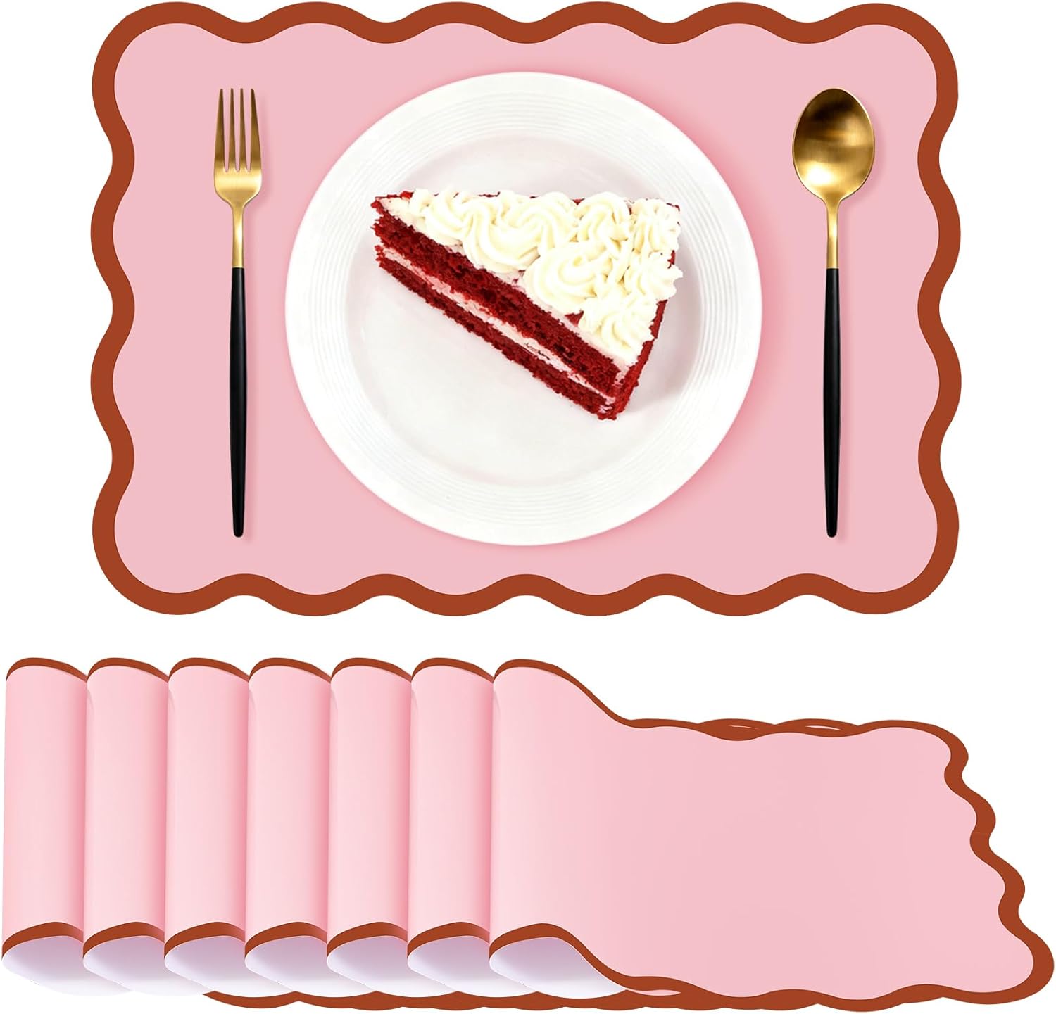 Pink scalloped placemats with a brown wavy border styled with gold flatware and dessert plate
