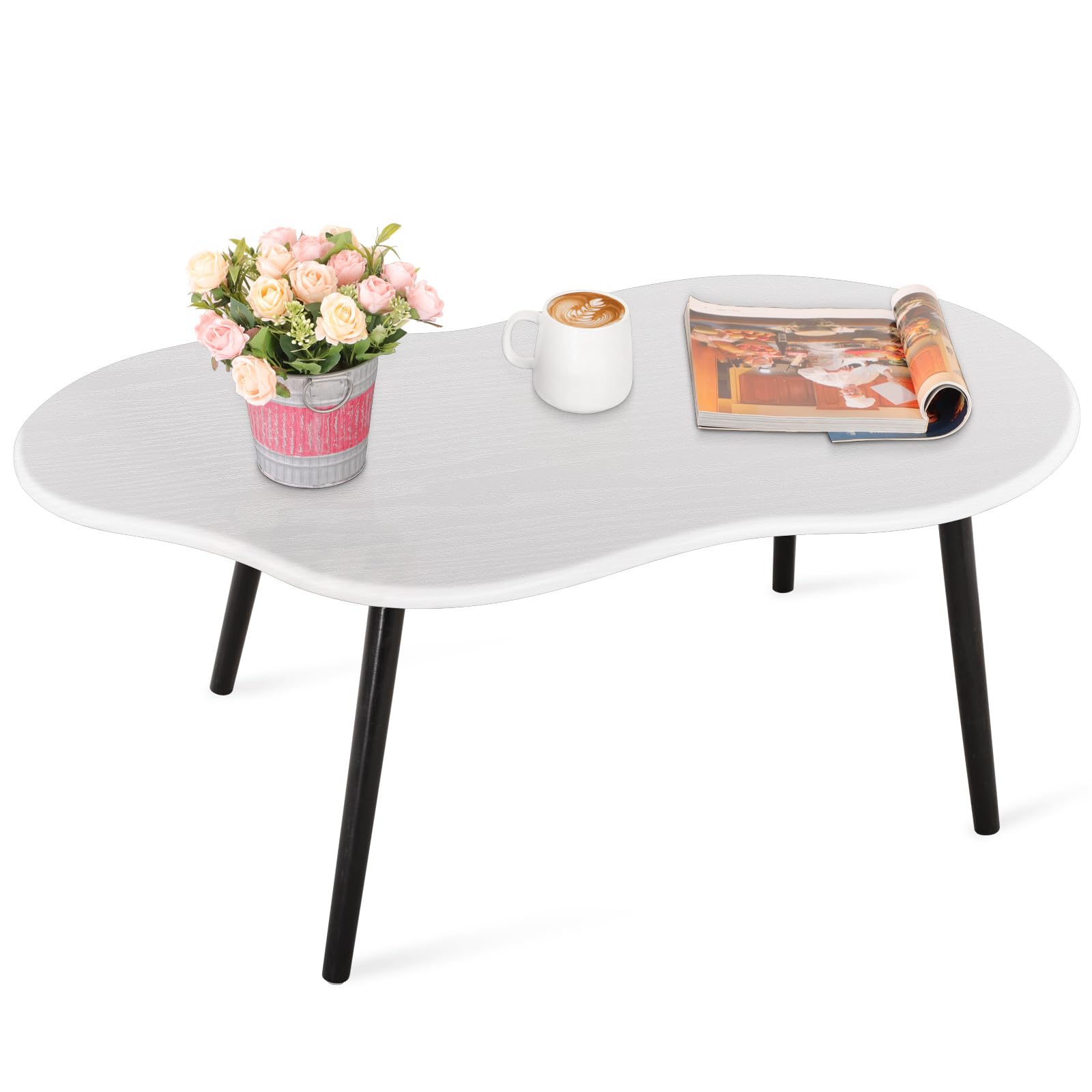Low white cloud-shaped coffee table with rounded edges and black tapered legs