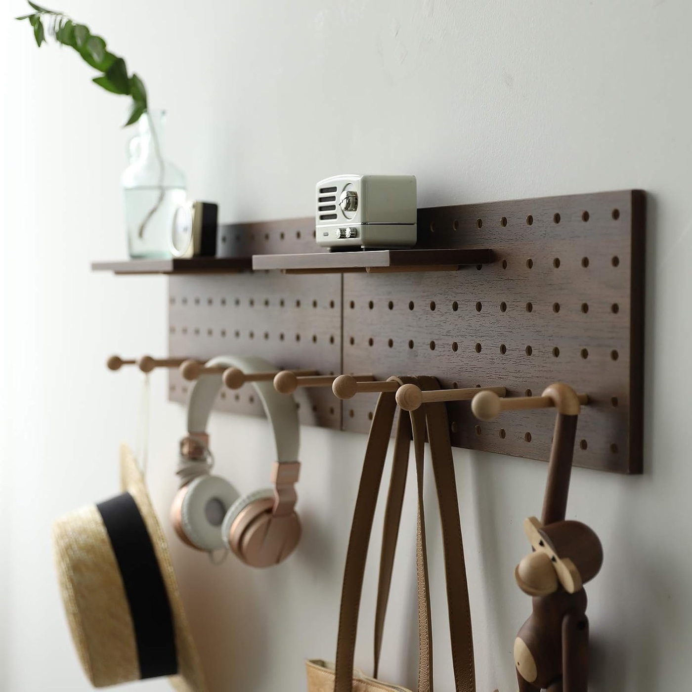 Walnut wood pegboard wall organizer with shelves and movable pegs